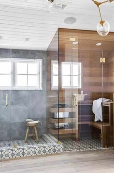 a bathroom with a walk in shower next to a sink and mirror on the wall