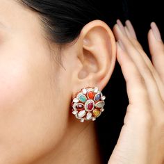 Product Details Enhance your special occasion attire with these stunning multi-stone earrings featuring an array of dazzling gemstones. They will add a sparkling splash of color to your ensemble and infuse your style with a touch of enchantment. A pair of gold finish handcrafted stud earrings studded with natural diamond, polki, and multi gemstones like natural cat's eye, natural coral, natural emerald, natural hessonite garnet, ruby glass filled, blue sapphire glass filled, yellow sapphire glas Luxury Multi-stone Earrings For Festive Occasions, Luxury Fusion Multi-stone Earrings, Luxury Traditional Multi-stone Earrings, Luxury Multi-stone Round Earrings, Polki Earrings, Hessonite Garnet, Natural Coral, Pearl Set, Yellow Sapphire