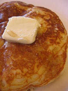 a stack of pancakes with butter and syrup on top that has the words hop pancakes written above it