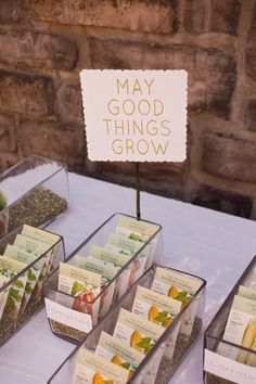 there are many small trays on the table with tea bags and plants in them