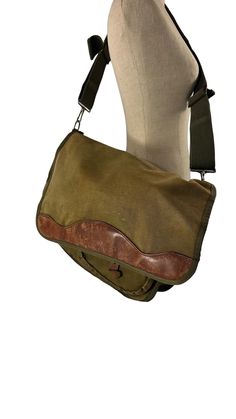 Measurements are 16"5 wide, 10" high, 4" deep with a 50" shoulder strap with a 20" drop. On the interior there is one large main compartment, lined in canvas, 2 small back pockets, 4 exterior pockets and front flap. This messenger is made of canvas with tan leather trim, silver tone hardware and the strap detaches.  Please note bag is not new and there are several scuffs, minor color variation, small tear on bottom and by the end of strap on canvas. 100% genuine vintage GOKEYS.  I want to stress Leather Messenger Bag, Leather Messenger, Canvas Leather, Leather Trim, Tan Leather, Leather Trims, Messenger Bag, Olive Green, Accessory Gift