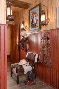 there is a cow hide in the corner of this room with cowboy boots on the floor