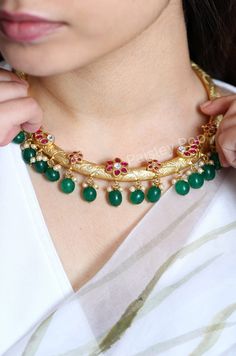 Our gold-plated hasli choker necklace is a Vintage tribal piece, with a contemporary spin on design. The traditional Indian hasli is a hand-carved work of art inspired by floral patterns. The choker delicately balances age-old craft and floral motifs encrusted with pink tourmaline stones with green agate stones hanging at the bottom along with shell pearls adding an ethnic yet contemporary touch to your style. Experience the divine allure of ancient Indian jewelry technique with this handcrafted Traditional Gold Plated Choker Necklace, Fusion Style Gold Choker With Tilla, Gold Fusion Choker With Tilla, Gold Fusion Choker With Tilla Detail, Gold Fusion Style Choker With Tilla, Gold Cutdana Fusion Necklace, Gold Kundan Necklace, Fusion Style For Rituals, Gold Fusion Kundan Necklace For Rituals, Gold Fusion Style Kundan Necklace For Rituals