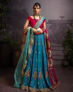 a woman in a blue and red lehenga