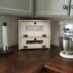 an old fashioned mixer sits on a kitchen counter