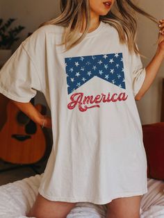 "FREE SHIPPING IN THE US! No order minimum!  Comfort Colors, Fourth of July Shirt, 4th of July Shirt, Independence Day, 4th of July, America Shirt, USA Tshirt, USA shirt, USA Flag Shirt ♥ The SHIRT  * This is a Comfort Colors 1717 shirt.  * This unisex t-shirt is intended to be loose/oversized for women to give a chic and laid back vibe. If you are looking for an oversized \"T-shirt Dress\" look, we recommend sizing up 2-3 sizes.  * Detailed sizing information can be found in the size chart in the photos.  * Printed in the USA. ♥ CARE  ＊Machine wash cold, inside-out, gentle cycle ＊Wash with mild detergent and similar colors ＊Tumble dry low or hang-dry ＊Do not bleach or fabric softeners ＊Do not iron directly onto the design ＊Do not dry clean ♥ PRODUCTION & SHIPPING ＊Each shirt is made to or 4th Of July Tops For Women, American Style Pre-shrunk Short Sleeve Shirt, Cotton Crew Neck T-shirt With Flag Print, Patriotic Screen Print Tops For Memorial Day, American Style Pre-shrunk Cotton T-shirt, Short Sleeve Cotton Americana Shirt, Americana Style Shirt With Flag Print For Independence Day, American Flag Print Shirt For Independence Day, Patriotic Shirt With Flag Print For Labor Day