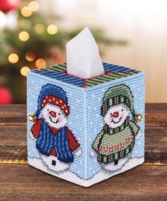 a tissue box with two snowmen on it