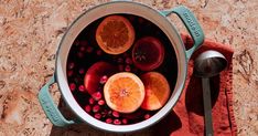 a pot filled with blood oranges and pomegranate