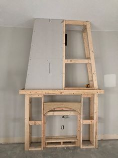 an unfinished shelf in the corner of a room