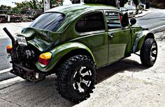 a green car parked on the side of the road