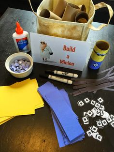 the materials needed to make this construction project are laid out on a table, including construction paper and glue