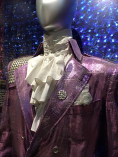 a close up of a mannequin wearing a purple suit