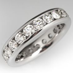 a white gold wedding ring with five diamonds