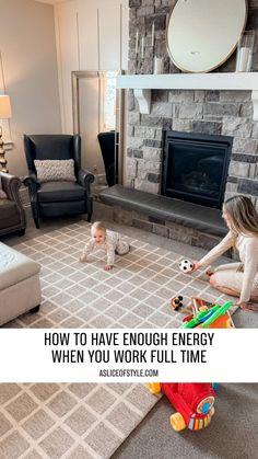 a woman playing with her baby in the living room while another child sits on the floor