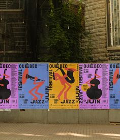 four posters on the side of a building in different colors and sizes, each with an image of a woman holding a musical instrument