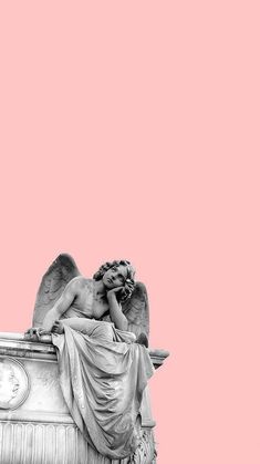 an angel statue sitting on top of a building next to a clock tower with a pink sky in the background