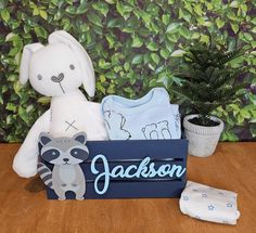 a stuffed animal sitting on top of a wooden table next to a potted plant