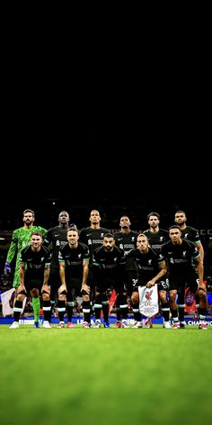 a group of soccer players pose for a team photo