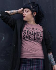 "🔥 Keep it Up and You'll Be the Strange Smell Coming From the Attic 😈 ABOUT THE SHIRT  Shirt features taped shoulder seams and a UNISEX fit ensuring comfort and style.  All colored heather shirts are a 35% ring-spun cotton and 65% easy-care polyester blend.  Sizes XS to 3XL (see size chart photos).  All of my tees are UNISEX sized (unless requested or specified otherwise!).  How does that affect your ordering?  If you're typically a LARGE in a women's sized tee, you'll likely be PERFECT in one Witchy Clothing, Witchy Shirt, Sister Outfits, The Attic, Funny Shirt, Workout Tee, Funny Shirts, Mens Tees, Clothing Items