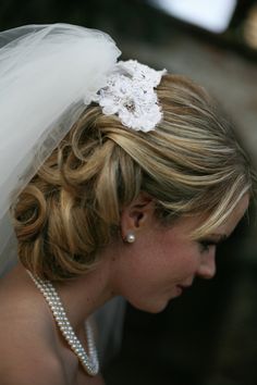 a woman wearing a wedding dress and veil