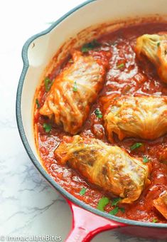 stuffed cabbage in tomato sauce with parsley garnish on the side, ready to be eaten