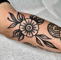 a person with a flower tattoo on their arm