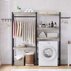 a washer and dryer in a room with shelving on the wall next to it