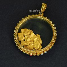 DESCRIPTION: Thank you for coming in! Unique Navratna 18k yellow gold pendant shaker locket! This piece has 4 sets of the 9 Navratna gemstones set into a spinning layer around the edge of the pendant. The middle is enclosed in sapphire glass and contains many loose 24k solid gold foil flakes that bounce around merrily inside! You'll get the Navratna pendant you see! SIZE: 50.7mmx37mmx6.7mm Bail: 9.3mmx6.7mm, 5.2mm hole Weight: 18.88 grams MATERIAL: 18k Solid yellow gold, 24k gold foil Gemstones: 22k Gold Locket Jewelry, Traditional Yellow Locket Jewelry, Yellow 22k Gold Round Pendant Jewelry, 22k Gold Amulet Locket Jewelry, Yellow Gold Medallion Temple Jewelry, Yellow Gold Round Jewelry, Spiritual 22k Gold Locket Jewelry, Antique Gold Openable Jewelry, Navratna Pendant