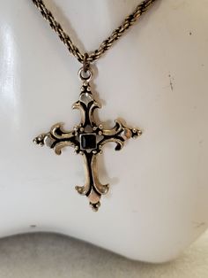 "This pendant necklace is being listed just in time for Easter. It is a silver tone fleur cross with a black glass square bead. It is made in a silver tone metal and a gray rope chain with lobster clasp. There are no markings on the cross or chain. The cross pendant came out of a jewelry jar from my local thrift and is good vintage condition. It will arrive in a gift box with FREE SHIPPING. Measures: 16 1/2\"L with 3\" extender chain Cross measures: 2\"L X 3/8\"W Material: Silver tone metal, bla Gothic Gold Cross Pendant Jewelry, Nickel-free Metal Cross Pendant Jewelry, Vintage Nickel-free Cross Necklace, Vintage Adjustable Cross Pendant Necklace, Adjustable Vintage Cross Pendant Necklace, Antique Silver Cross Necklace Gift, Vintage Nickel-free Crucifix Necklace, Antique Silver Cross Necklace For Gift, Antique Silver Cross Necklace As Gift