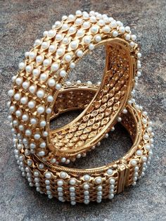 Pair of Bangles, Gold Finish Kada with Pearls, Size 2-6 or 2-8 Listing is for a PAIR of HINGED bangles Size 2:6 is approximately 2.375 inches Size 2:8 is approximately 2.5 inches No returns or exchanges unfortunately Pearl Bangles Gold, Fancy Diamond Ring, Bangles Gold, Antique Jewellery Designs, Pearl Bangle, Antique Gold Jewelry, Bangles Jewelry Designs, Blouse Work, Bangle Designs