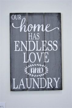 a wooden sign that says our home has endless love and laundry on the front wall