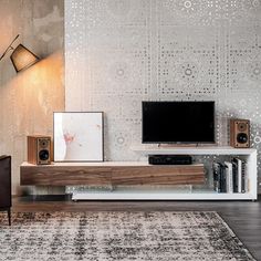 a living room with an entertainment center and large screen tv on the wall above it