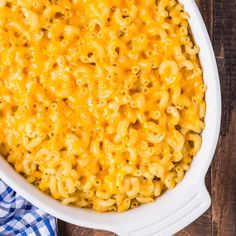 macaroni and cheese in a white casserole dish on a wooden table