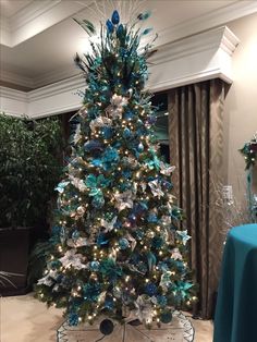 a decorated christmas tree with blue and silver decorations