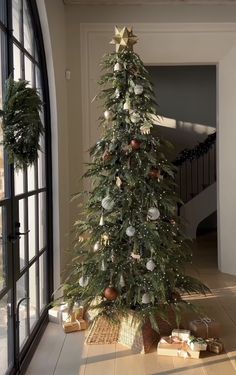 a decorated christmas tree sitting in the middle of a room