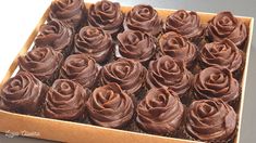 a box filled with chocolate cupcakes on top of a table