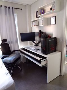 a room with a desk, chair and computer on it