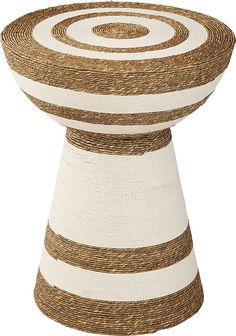 a large white and brown vase sitting on top of a table