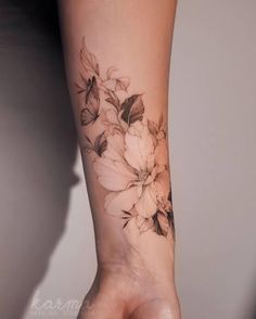 a woman's arm with flowers on it