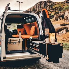 the back end of a van with its trunk open and luggage in it's cargo compartment