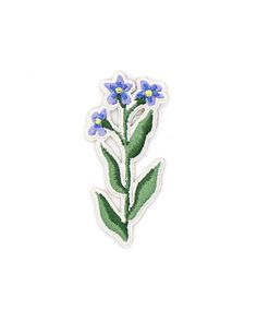 a blue flower with green leaves is shown on a white background