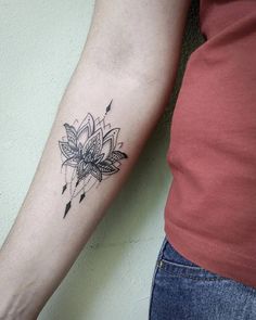 a woman's arm with a tattoo on it and a flower in the middle