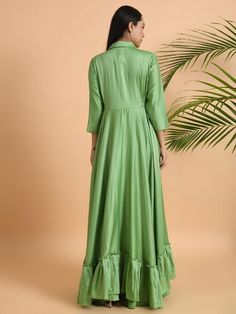 A shawl collared cotton silk maxi dress with flared and flounced bottom, side pockets, and long sleeves Garment measurements (in Inches): Small: Bust - 39", Waist - 29" Medium: Bust - 42", Waist - 32" Large: Bust - 45", Waist - 35" Length: 55-56", Sleeve length: 17" Fabric: Cotton Silk Color: Green Fit: Model height is 5'7" Model is wearing a size S Loose and comfortable fit. Instructions: Hand wash separately in cold water Note: Available in other colors Pants not included with the product Pant Green Rayon Long Sleeve Maxi Dress, Spring Long Sleeve Gown With Ruffles, Green Silk Long Sleeve Maxi Dress, Silk A-line Maxi Dress For Festive Occasions, Fitted Maxi Dress With Ruffle Hem And Long Sleeves, Fitted Long Maxi Dress With Ruffles, Silk Anarkali Gown With Long Sleeves, Fitted Anarkali Maxi Dress With V-neck, Silk Maxi Dress With Ruffle Hem