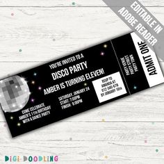 a black and white party ticket sitting on top of a wooden table with confetti