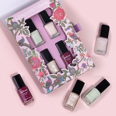 A set of six Spring Fling Lakur nail polish bottles from LONDONTOWN are arranged on a pink surface, with one bottle placed in a decorated box, reminiscent of a bouquet of vibrant colors perfect for gifting to mom. Waterproof Eyeliner Pencil, Nail Polish Set, Colored Eyeliner, Long Lasting Nails, Nail Polish Sets, London Town, Spring Fling, Waterproof Eyeliner, Hair Fragrance