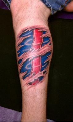 a man's leg with a red, white and blue tattoo on it