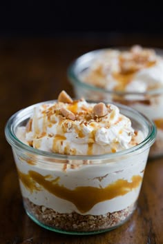 two desserts in small glass dishes on a wooden table