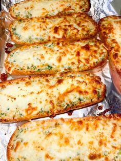 four cheesy bread sticks sitting on top of tin foil covered in melted cheese