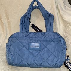 The Marc Jacobs The Small Weekender Quilted Nylon Duffle Bag Color Is Blue Heaven New With Tags Msrp: $275 A Medium Sized Quilted Nylon Duffle Bag, Perfect For Your Next Quick Trip Versatile! Wear It By Either The Handles, Shoulder Straps Or Crossbody Webbing Strap Top Zip Closure Front Slip Pocket Interior Zip Pocket Bag Is Expandable- So The Approx Measurements When Lying Flat / Empty Are 16” In L X 10 In H X 6 In W It Can Be Filled To Larger Dimensions W The Qualities Of This Fabric Strap 64i Blue Nylon Shoulder Bag With Double Handle, Blue Nylon Shoulder Bag With Detachable Strap, Blue Quilted Travel Bags, Blue Quilted Nylon Bags, Blue Quilted Bag For On-the-go, Blue Quilted Shoulder Bag For Travel, Travel Slippers, Travel Clutch, Chic Quilts