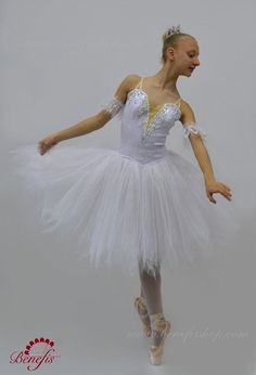 A white Degas (knee length) tutu for the role of the Snow Flake in the ballet The Nutcracker. The bodice of this tutu is made with white shiny brocade and fastens in the back with a double row of hooks and eyes. The bodice features a deep V neck with a nude insert. Decorations are made with silver appliques, crystals and sequins, while little crystals are sewn onto the nude insert. Arm bands included. Head piece NOT included. The 5 layers, soft net white tutu skirt has scalloped edges and ruffle White Ballet Tutu Dress For Party, Fitted White Tutu Dress For Costume Party, White Tulle Tutu Dress For Debutante Ball, White Fitted Tutu Dress For Costume, Ballet The Nutcracker, White Tutu Skirt, Ballet Costume, White Tutu, The Ballet